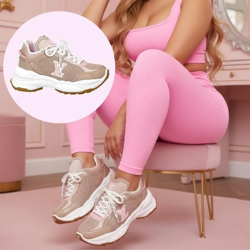 Model wearing designer luxe running trainers in beige/pink